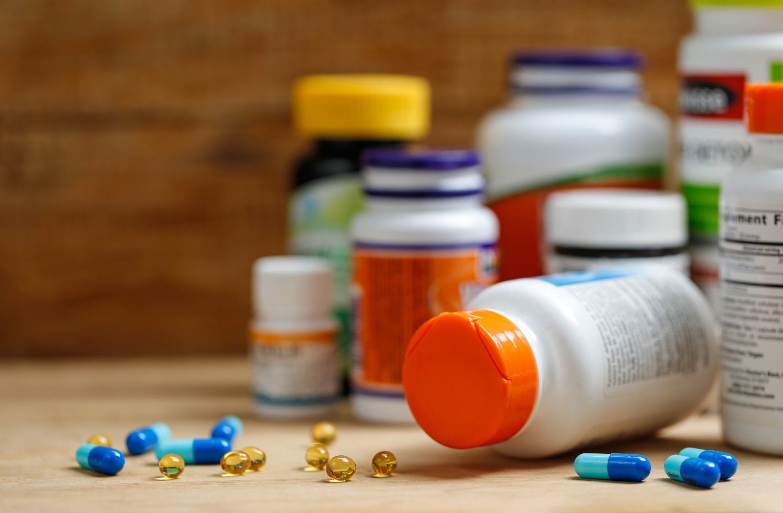 Supplement bottles on a wooden desk